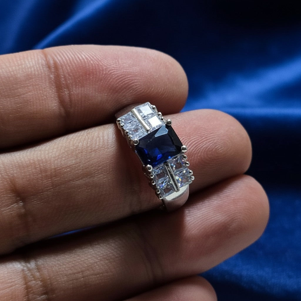 SilverStones.Pk elegant ladies ring with a central square blue zircon and surrounding clear square zircons. Color silver.