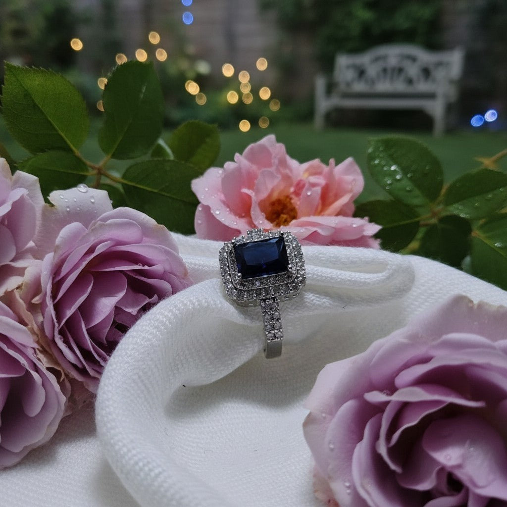 SilverStones.Pk elegant ladies ring with a deep blue square zircon center and pave set stones on band.