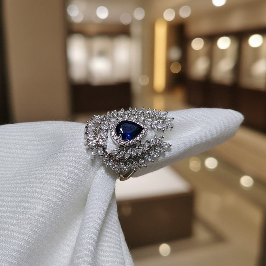 SilverStones.Pk A+ quality imitation ring with a pear-cut blue zircon center stone surrounded by clear zircon accents.