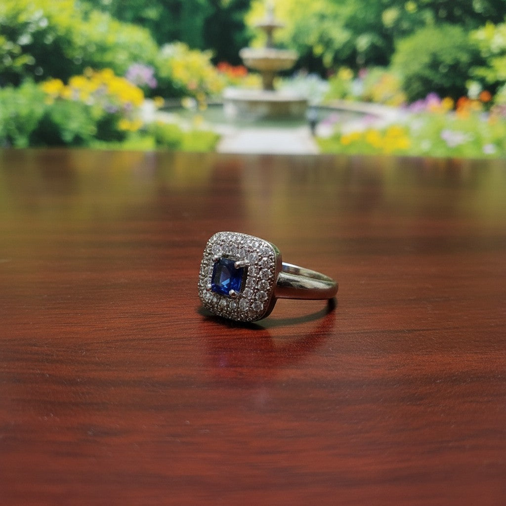 SilverStones.Pk designer ladies ring with a central blue zircon stone surrounded by clear zircon stones. Color silver.