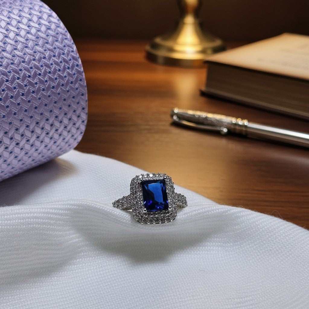 SilverStones.Pk elegant ladies ring with a central rectangular blue zircon surrounded by smaller clear zircons. Silver band.