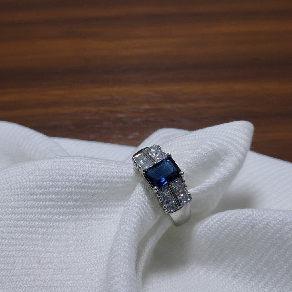 SilverStones.Pk elegant ladies ring with a central dark blue zircon and surrounding clear zircon stones, set in silver.