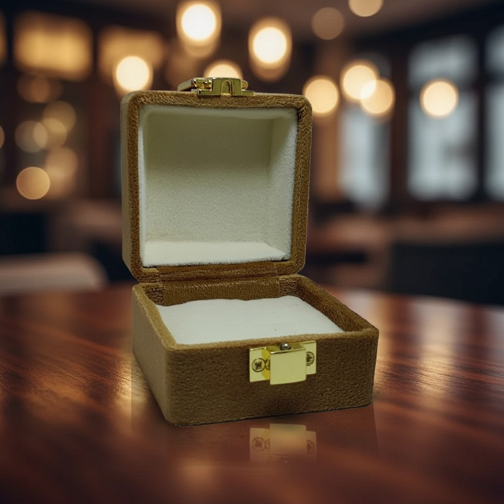SilverStones.Pk brown velvet ring box with gold clasp, plush interior for jewelry.