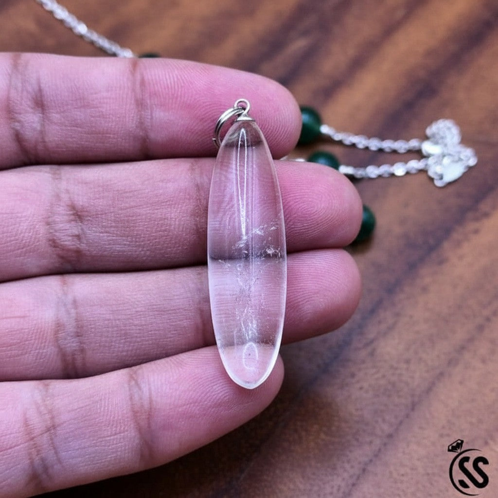 SilverStones.Pk clear quartz pendant, a transparent, naturally shaped crystal with a nickel-free metal hook. Ideal for energy amplification and clarity.
