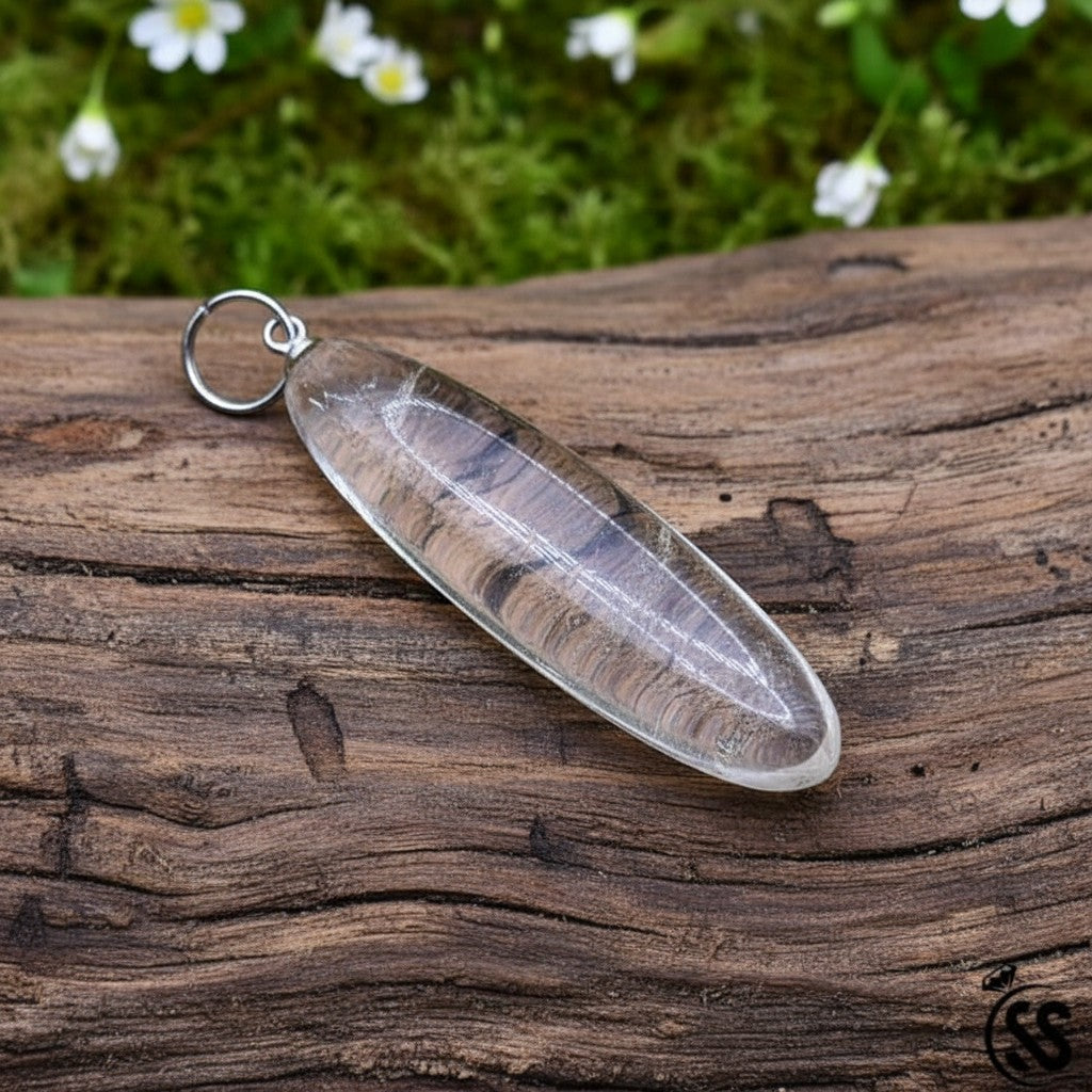 SilverStones.Pk clear quartz pendant, a transparent, naturally shaped stone with a nickel-free metal hook.