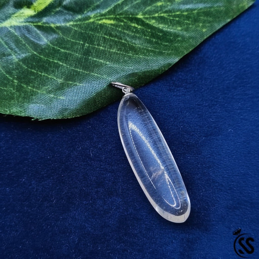 SilverStones.Pk clear quartz pendant, a polished, transparent natural stone with a simple metal hook. Ideal for energy amplification and clarity.