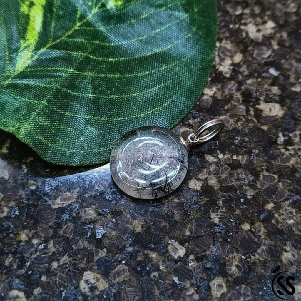 SilverStones.Pk clear quartz pendant with black inclusions, round cut, metal hook, spiritual jewelry.