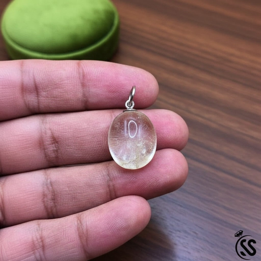 SilverStones.Pk clear quartz pendant, a transparent oval natural stone with a nickel-free metal hook, ideal for energy amplification and clarity.