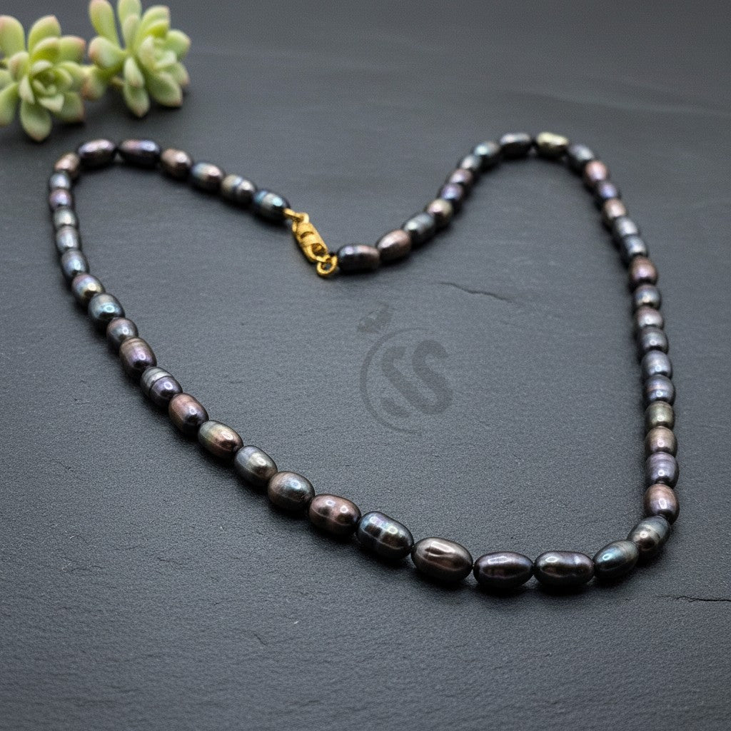 SilverStones.Pk iridescent dark pearl necklace with gold clasp, oval pearls.