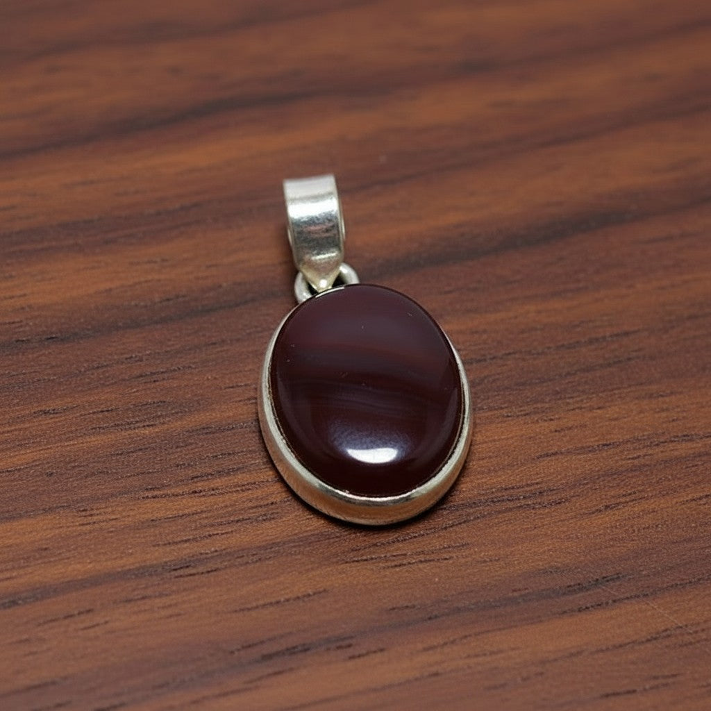 SilverStones.Pk oval dark red aqeeq stone pendant set in silver. A symbol of strength and protection.