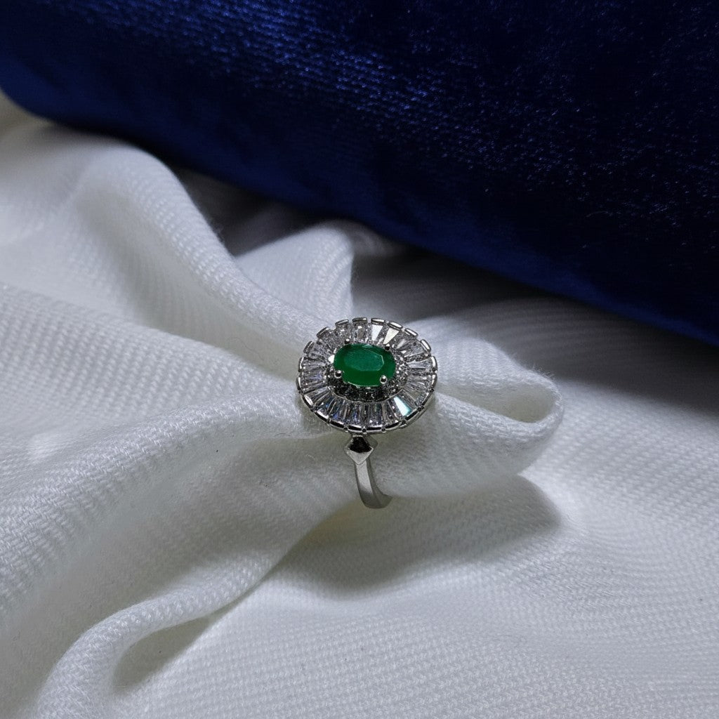 SilverStones.Pk designer ladies ring with oval emerald center stone surrounded by baguette and round zircon stones. Silver color.