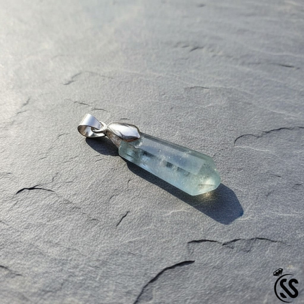 SilverStones.Pk multi-colored natural fluorite crystal pendant with a clear, faceted hexagonal shape and a silver-toned metal hook.