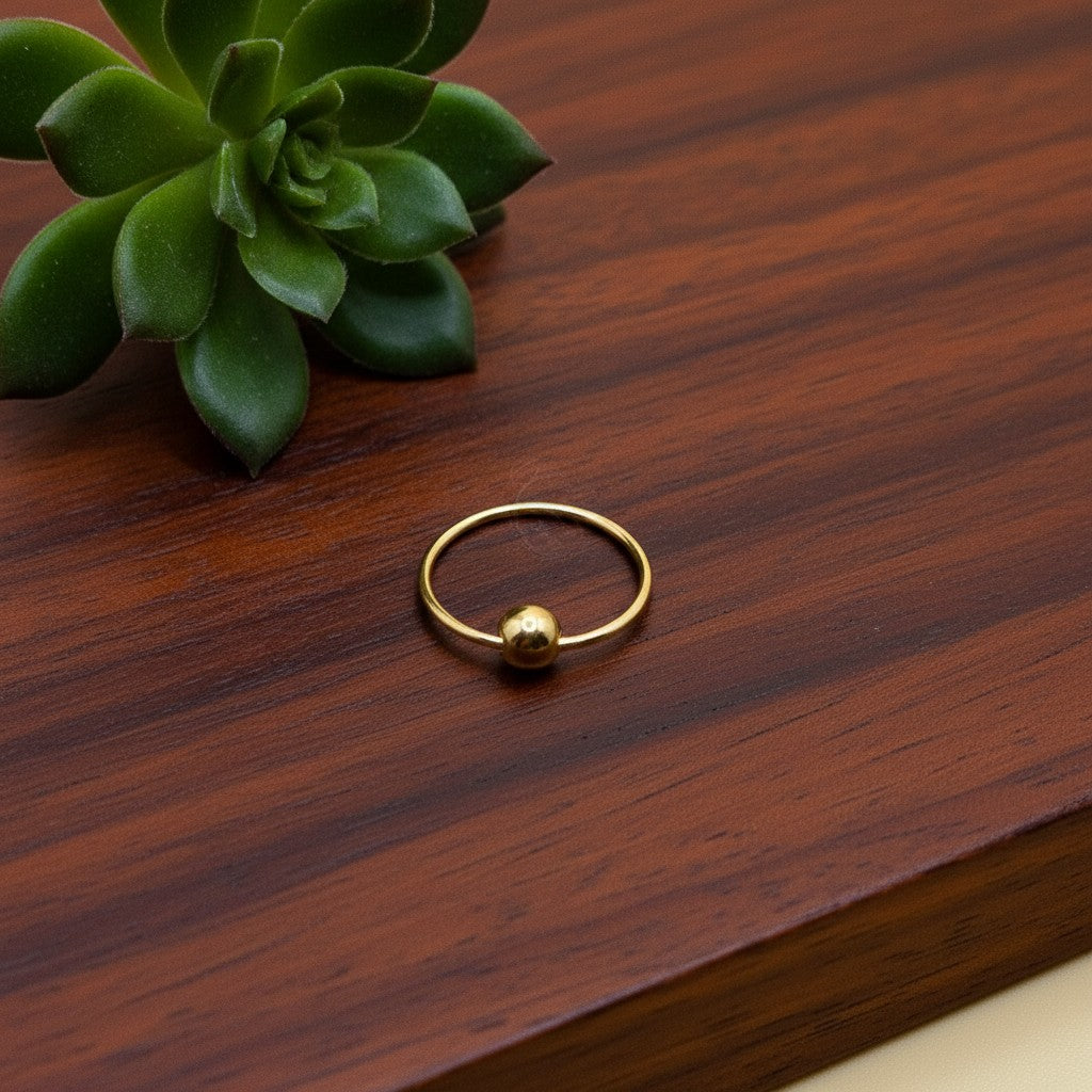 SilverStones.Pk 10mm 24-carat gold-plated sterling silver nose ring with a single bead accent.