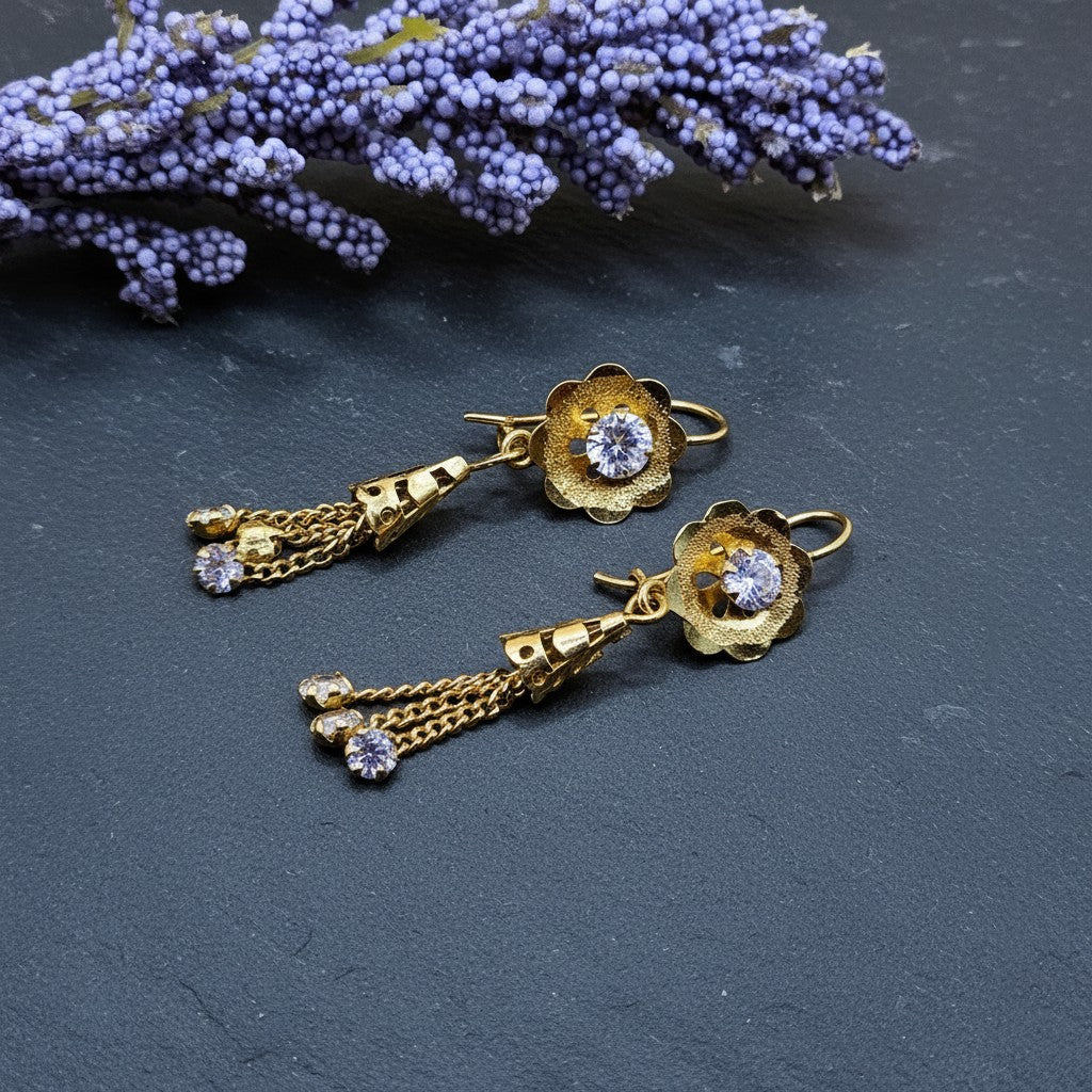 SilverStones.Pk 24 carat gold plated pure silver earrings with floral design and dangling chains with small crystals.
