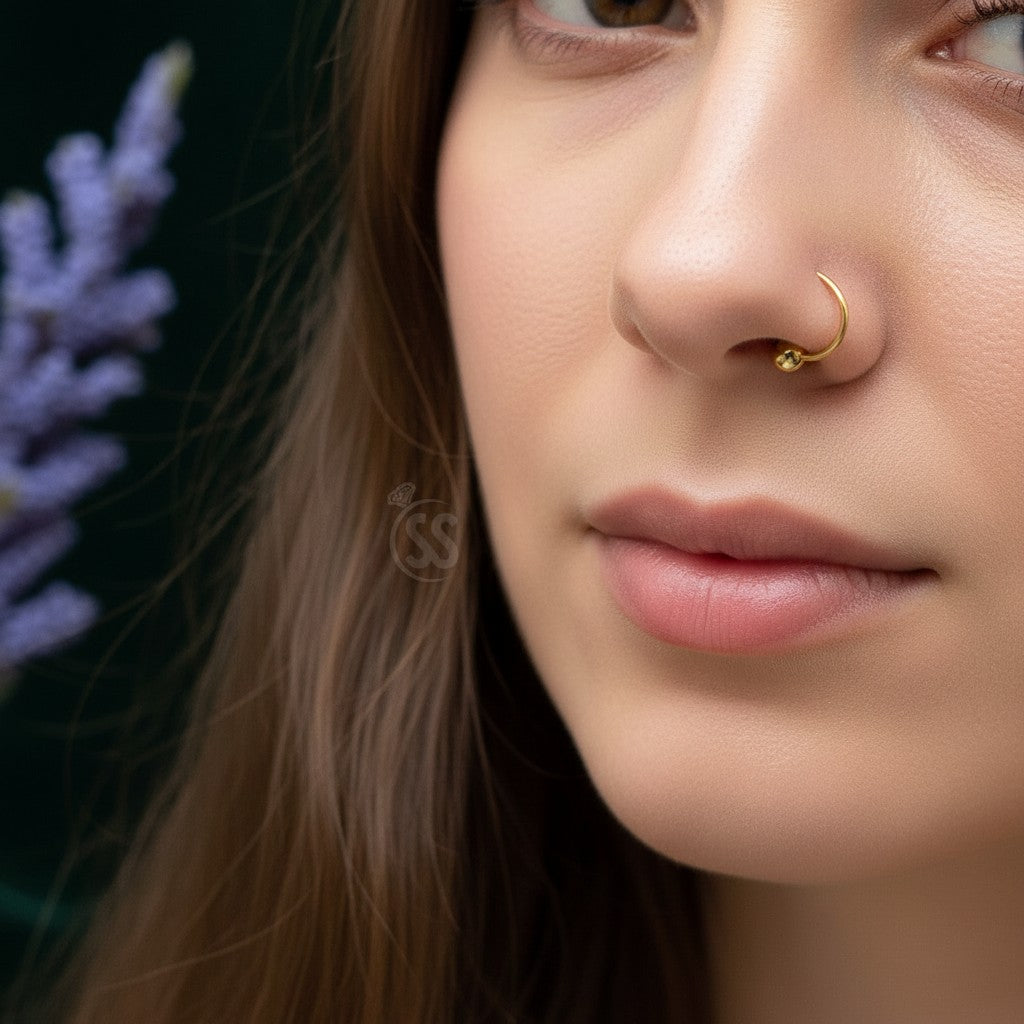 SilverStones.Pk 10mm 24-carat gold-plated sterling silver nose ring with a small ball accent. Hypoallergenic.