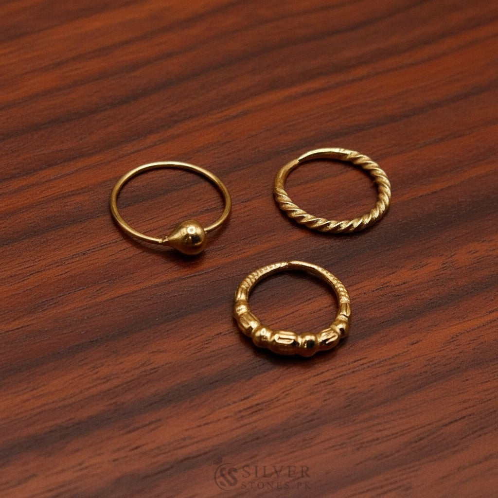 SilverStones.Pk pack of 3 gold-plated pure silver nose rings. Features a ball, twisted, and beaded design. Hypoallergenic and elegant.