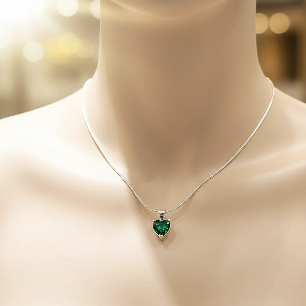 SilverStones.Pk sterling silver pendant with a deep green heart-shaped zircon stone, presented in a pink jewelry box.