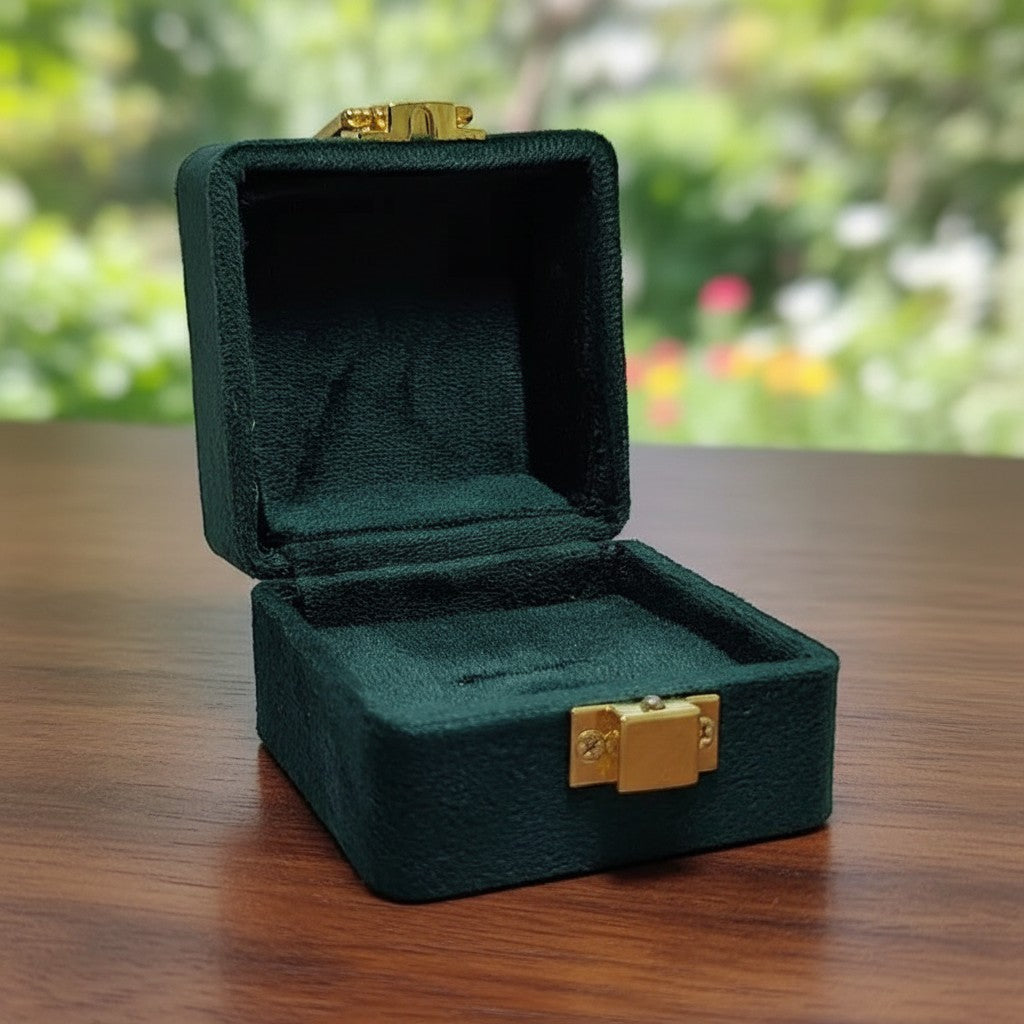SilverStones.Pk dark green velvet ring box with gold clasp, plush interior for ring protection.