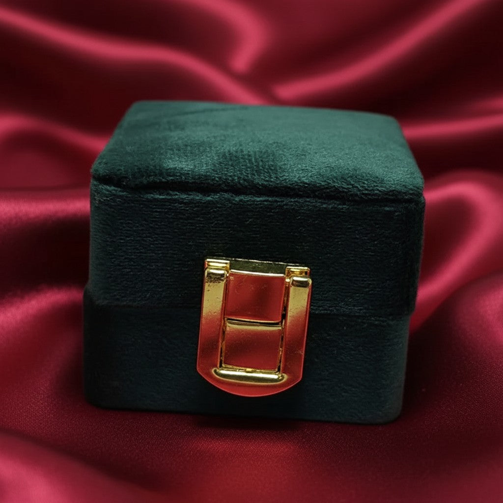 SilverStones.Pk dark green velvet ring box with gold clasp closure, ideal for proposals and special occasions.