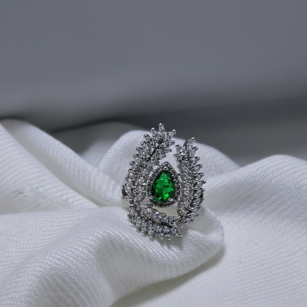 SilverStones.Pk designer ladies ring with a pear-shaped green zircon center stone and surrounding clear zircon accents.