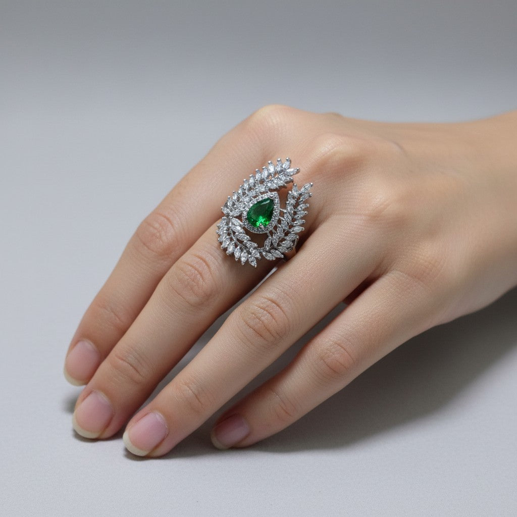 SilverStones.Pk designer ladies ring with a pear-shaped green zircon center stone surrounded by clear zircon accents.