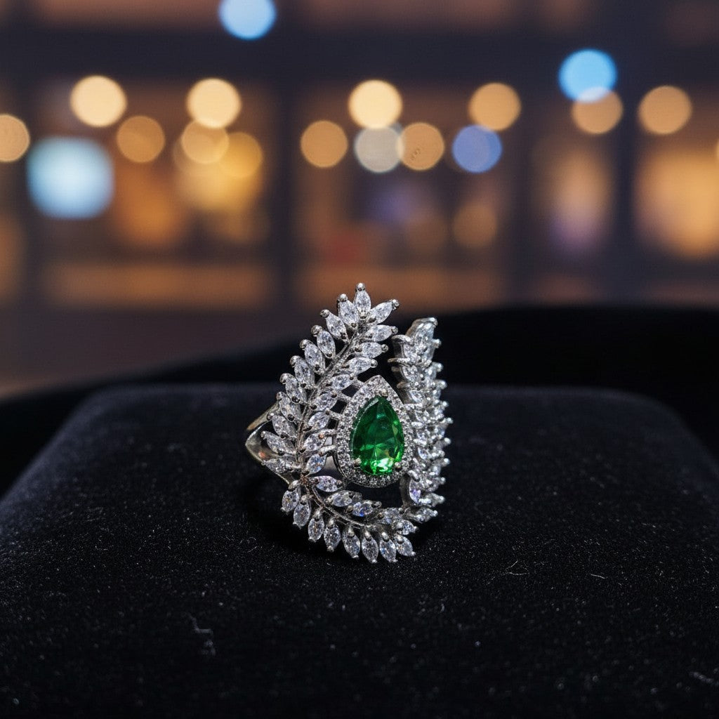 SilverStones.Pk designer ladies ring with a pear-shaped green zircon and surrounding clear zircon stones in a leaf design.