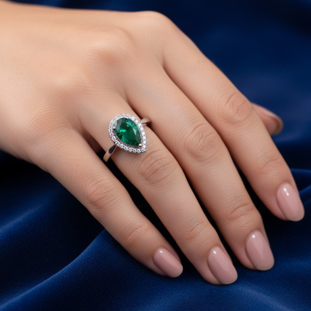 SilverStones.Pk designer ladies ring with pear-cut green zircon and surrounding white stones, color silver.