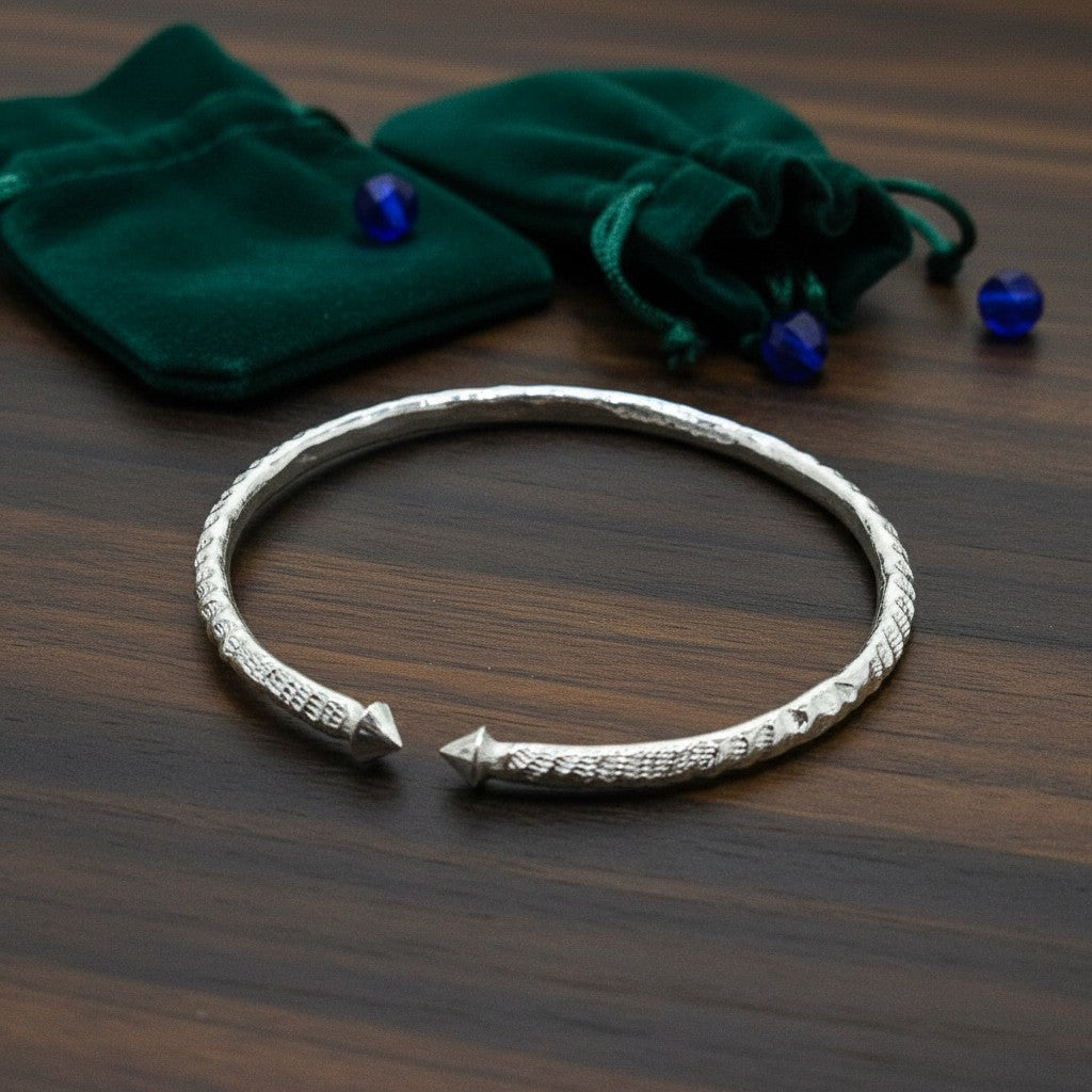 SilverStones.Pk handmade pure silver wrist band for kids, 1.5 inches, adjustable, with textured design and pointed ends.