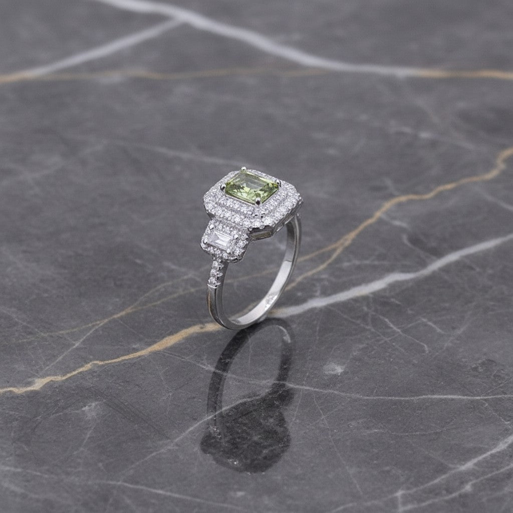 SilverStones.Pk Italian 925 sterling silver ring with a central green square stone surrounded by small clear stones.