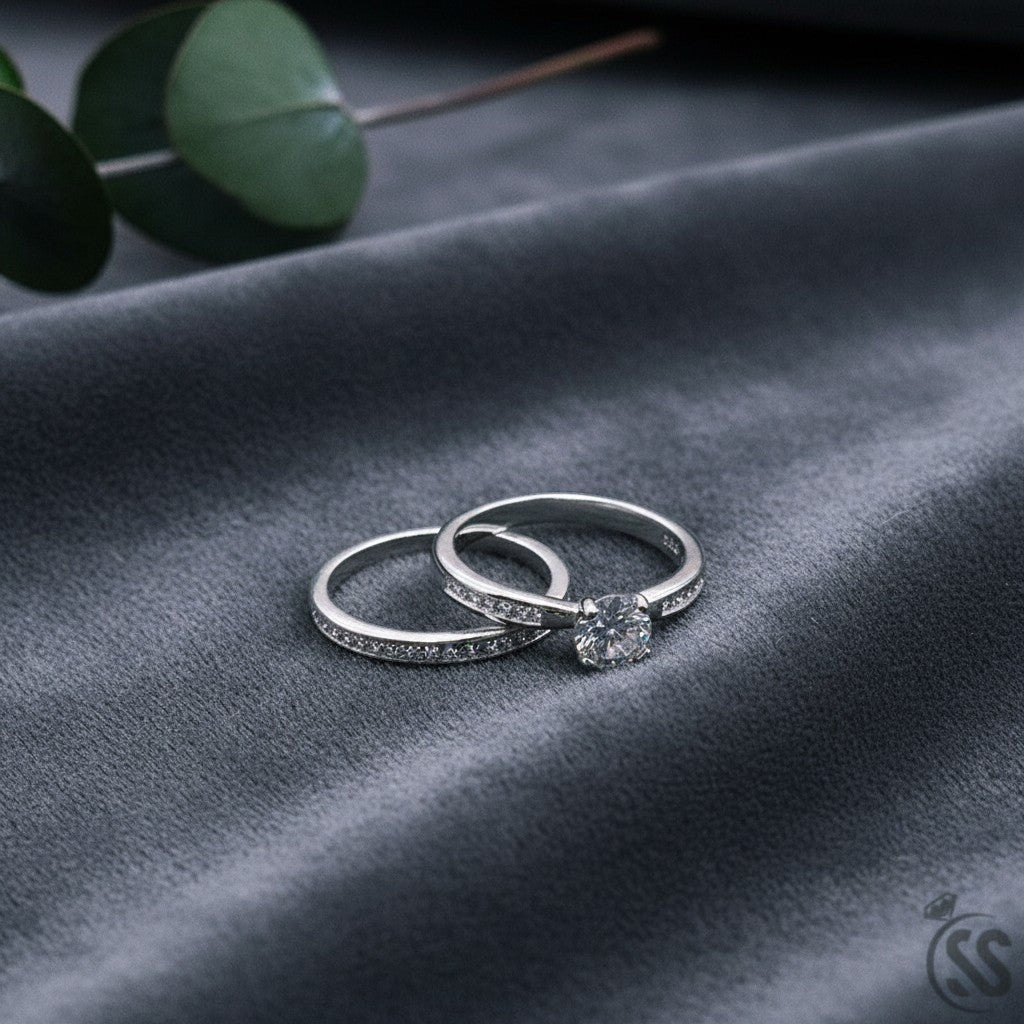 SilverStones.Pk pair of Italian 925 sterling silver rings with white zircons. One ring features a solitaire stone, the other a band of small stones.