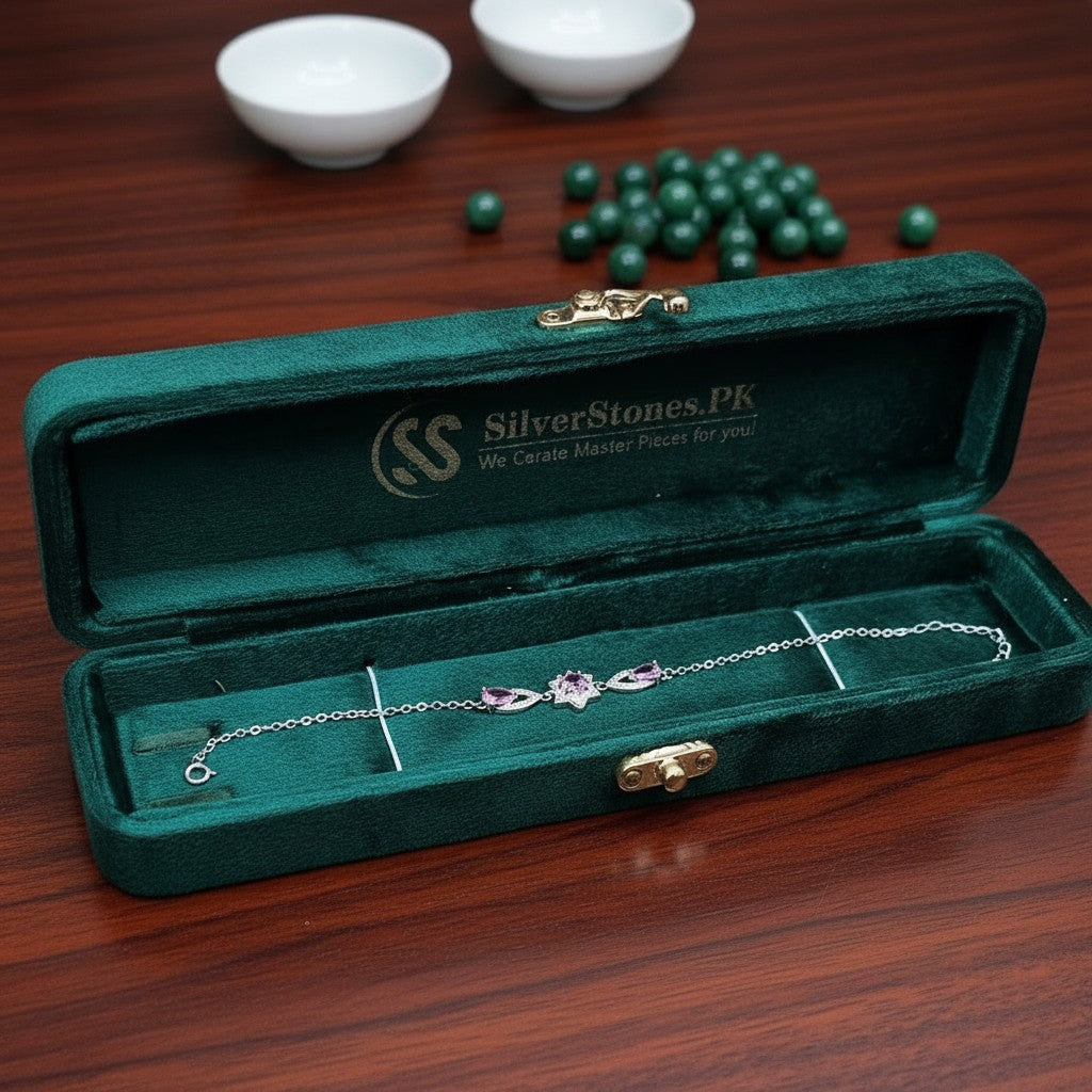 SilverStones.Pk sterling silver bracelet with purple zircon stones in a floral design, presented in a velvet box.