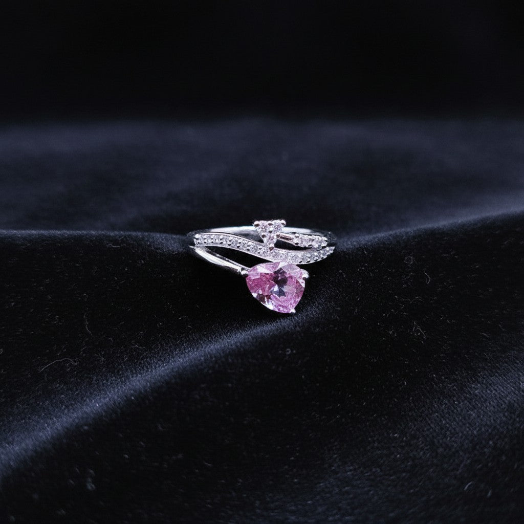 SilverStones.Pk 925 Italian sterling silver ring with a pear-cut pink zircon and small clear zircons.