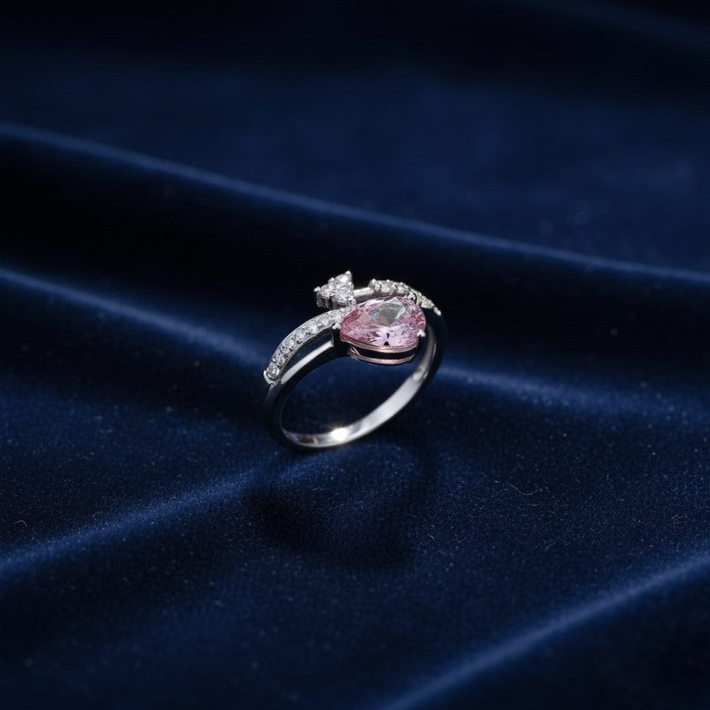 SilverStones.Pk 925 Italian silver ring with pear-cut pink zircon and small clear zircons.