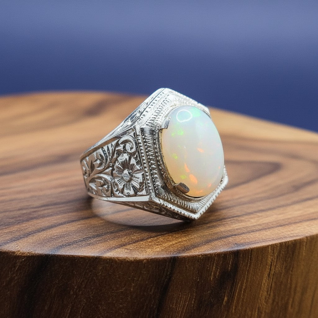 SilverStones.Pk men's pure silver ring with a large oval white opal stone and intricate floral carvings on the band.