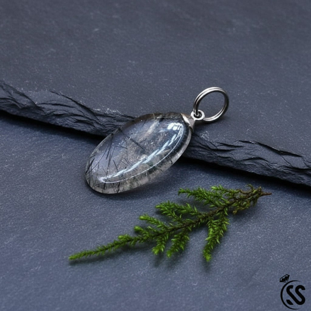 SilverStones.Pk oval clear quartz pendant with black inclusions and metal hook. Unisex spiritual jewelry.