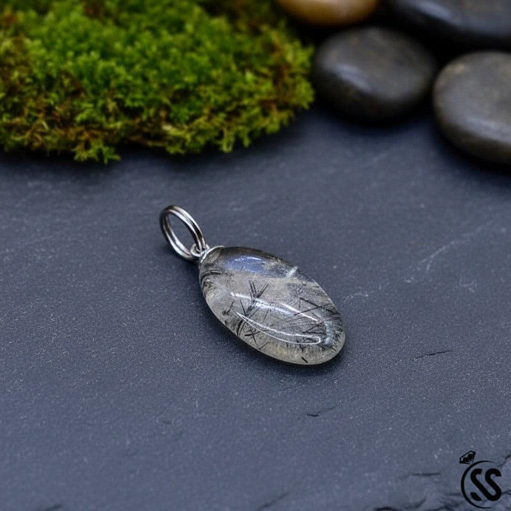 SilverStones.Pk oval clear quartz pendant with black inclusions and metal hook. Unisex spiritual jewelry.