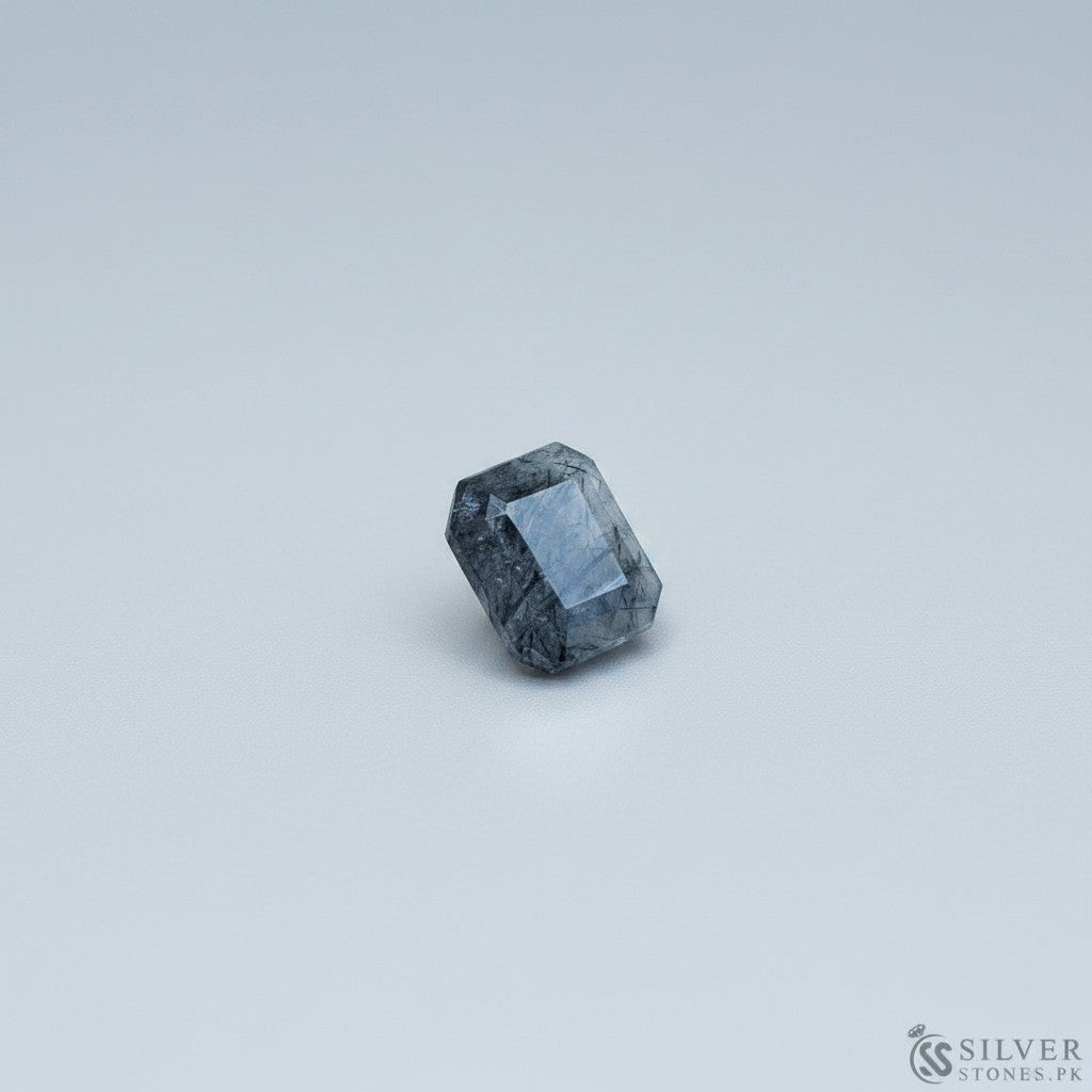 SilverStones.Pk real Muh-e-Najaf stone, faceted dark grey gemstone with natural inclusions, round shape.