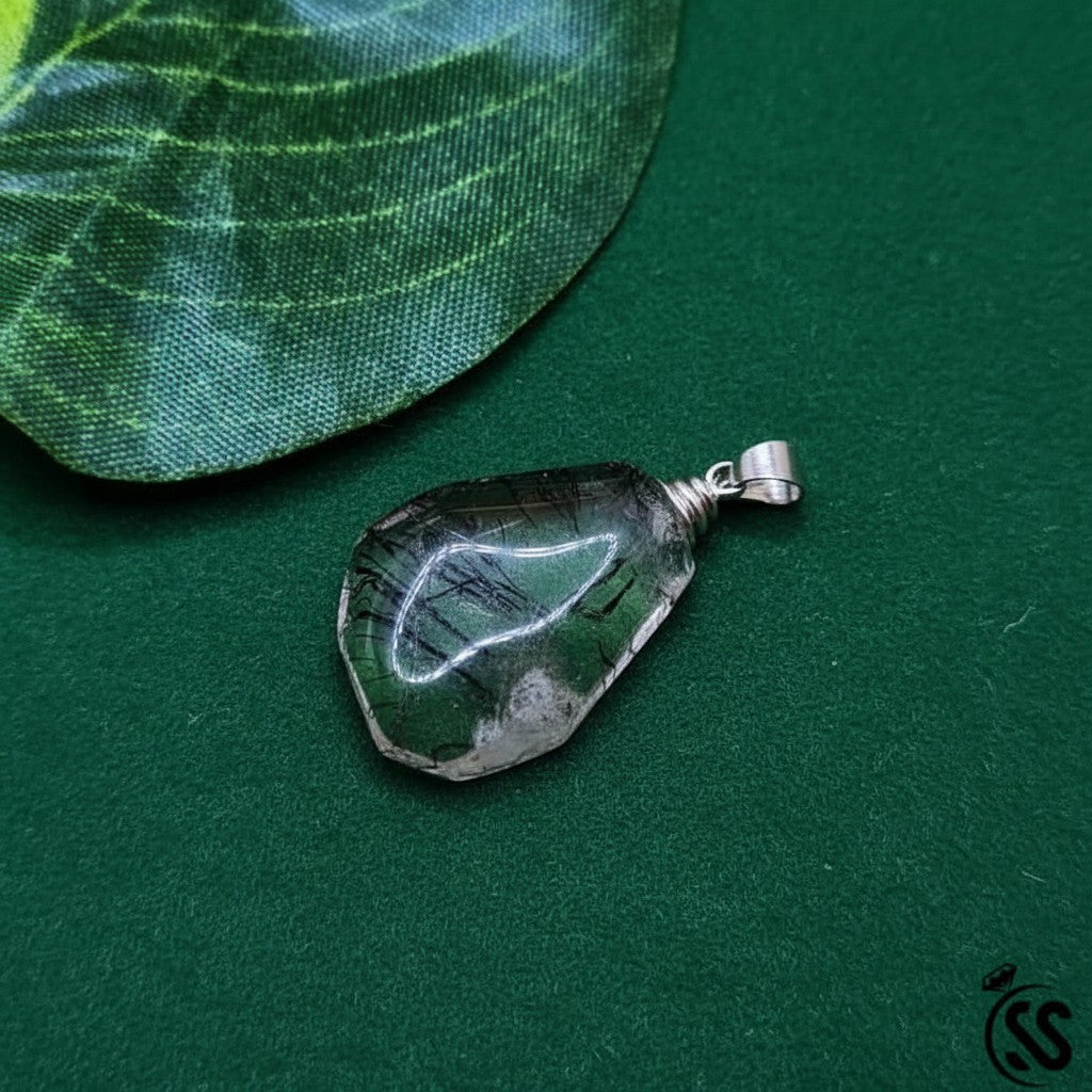 SilverStones.Pk natural clear quartz pendant with black inclusions and metal hook. Unisex spiritual jewelry.