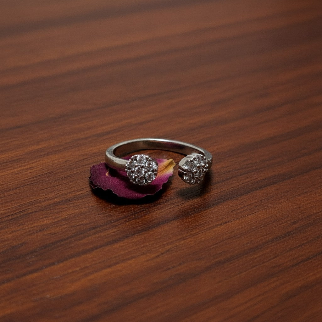 SilverStones.Pk open ring with two circular clusters of clear zircon stones, crafted from color silver.