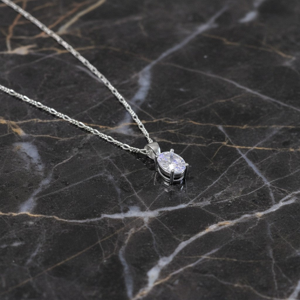 SilverStones.Pk sterling silver necklace with oval-cut clear cubic zirconia pendant and figaro chain.