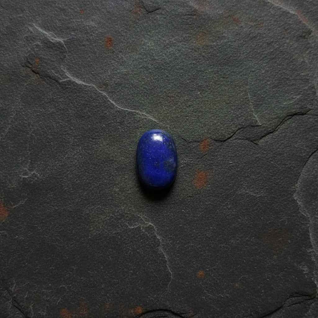SilverStones.Pk oval Lapis Lazuli gemstone cabochon with flecks of pyrite, ideal for jewelry making.