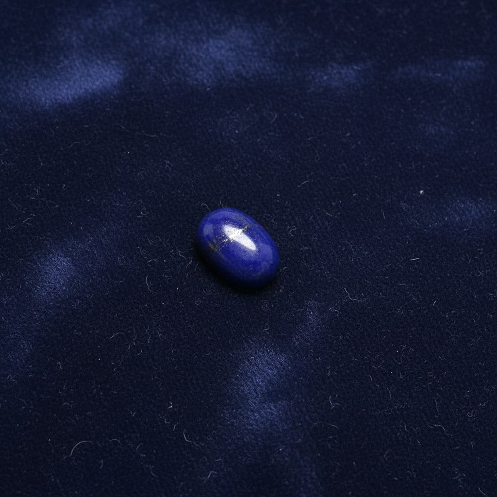 SilverStones.Pk oval Lapis Lazuli gemstone cabochon with pyrite flecks, ideal for jewelry making.