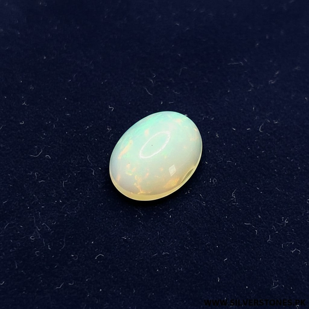 SilverStones.Pk oval white Ethiopian opal gemstone with a radiant play-of-color, ideal for jewelry.