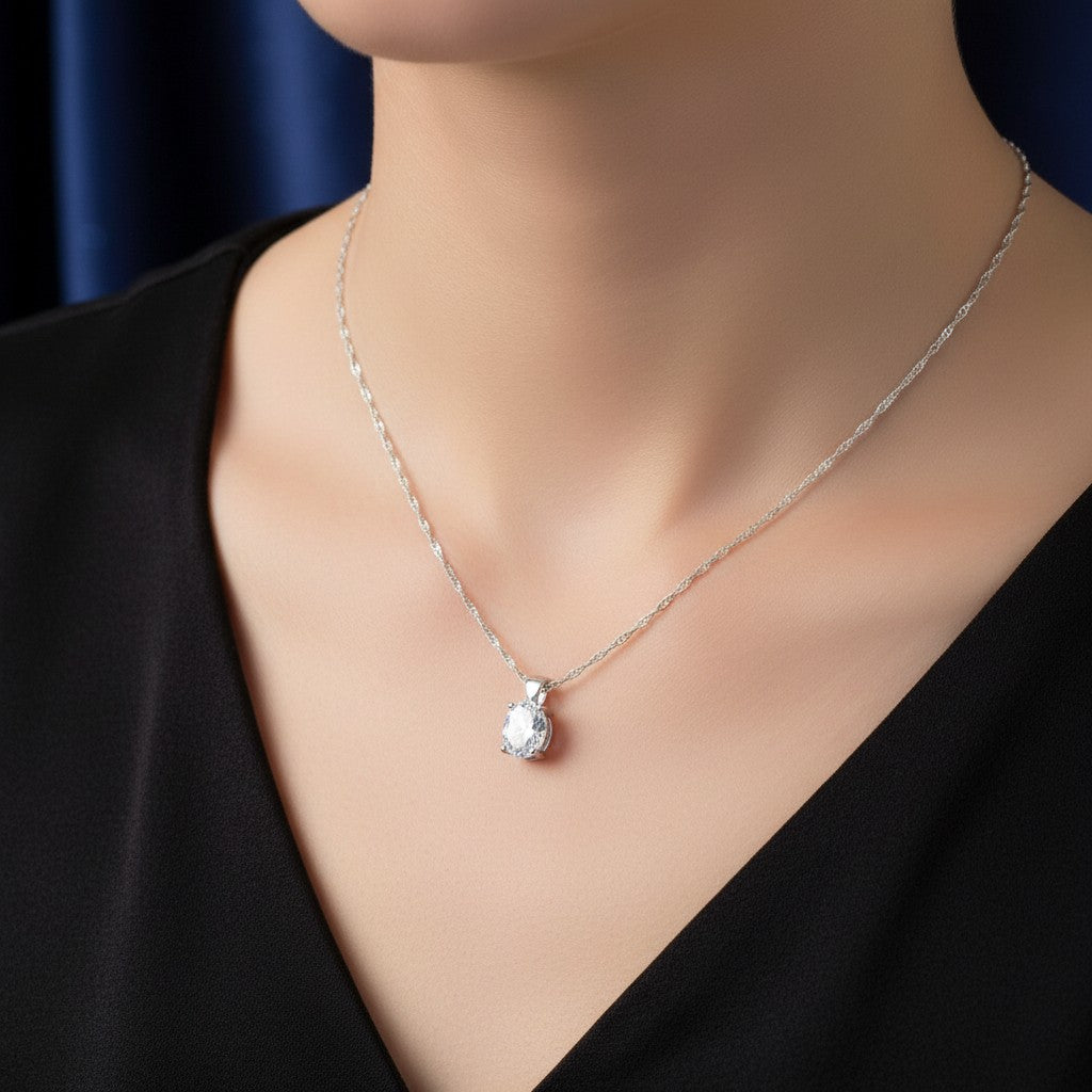 SilverStones.Pk oval-cut cubic zirconia pendant necklace on a delicate figaro chain, crafted from sterling silver.