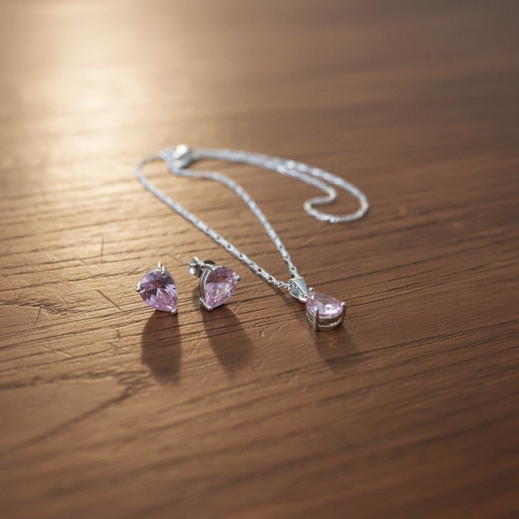SilverStones.Pk pink pear-cut zircon pendant necklace and matching stud earrings set in sterling silver.