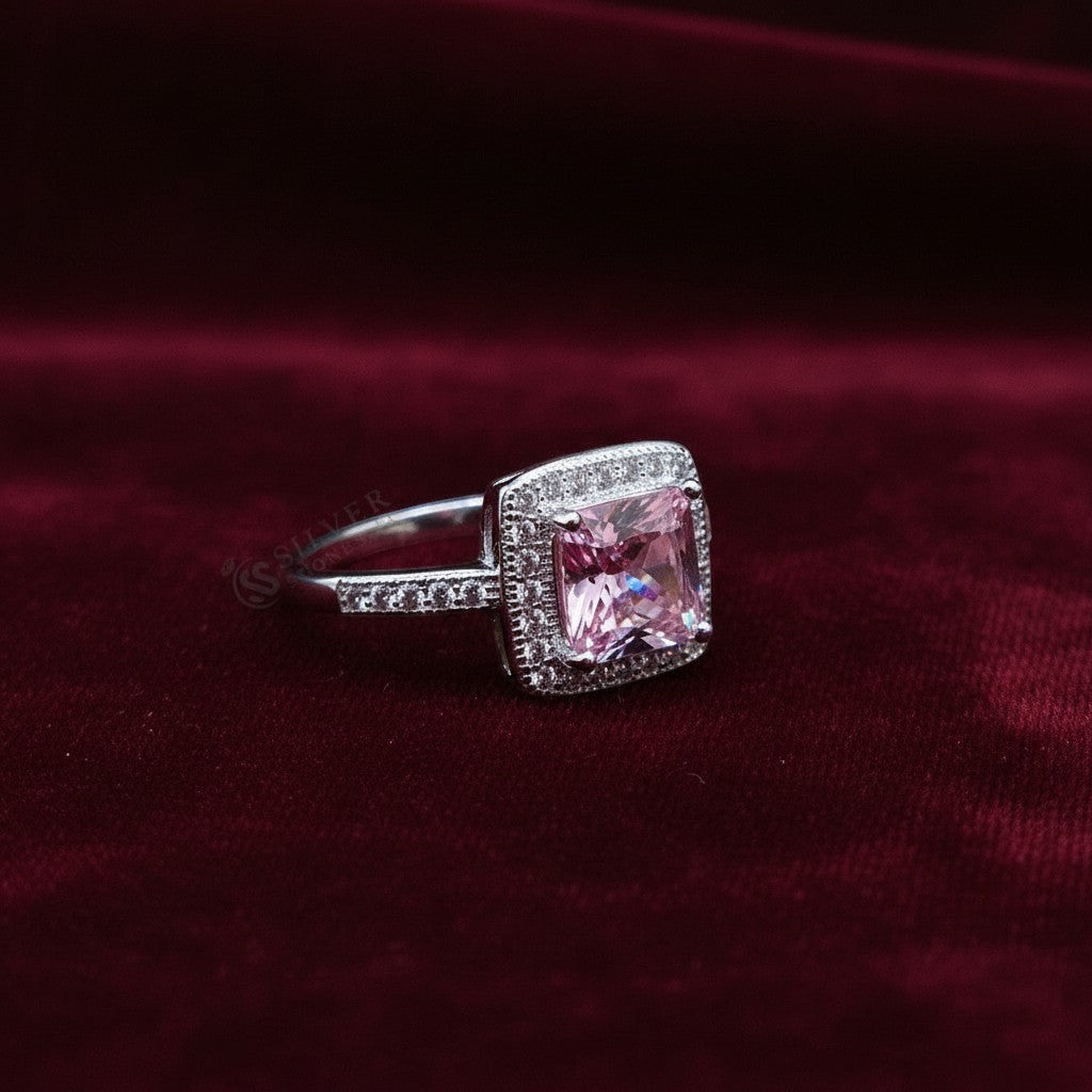 SilverStones.Pk pink zircon halo ring in 925 Italian sterling silver. Features a square-cut pink center stone surrounded by small clear stones.