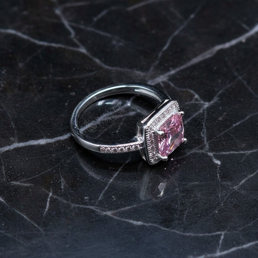 SilverStones.Pk pink zircon halo ring in 925 Italian sterling silver. Features a central square-cut pink stone surrounded by smaller clear stones.
