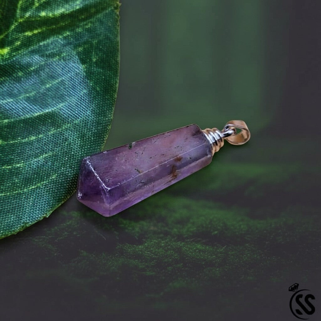 SilverStones.Pk purple fluorite crystal pendant with a faceted hexagonal shape and silver metal hook. Natural stone for clarity and focus.
