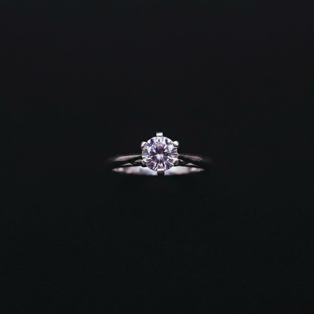 SilverStones.Pk ladies' 1 carat round purple moissanite diamond ring in silver, set on a brown textured surface with green foliage.