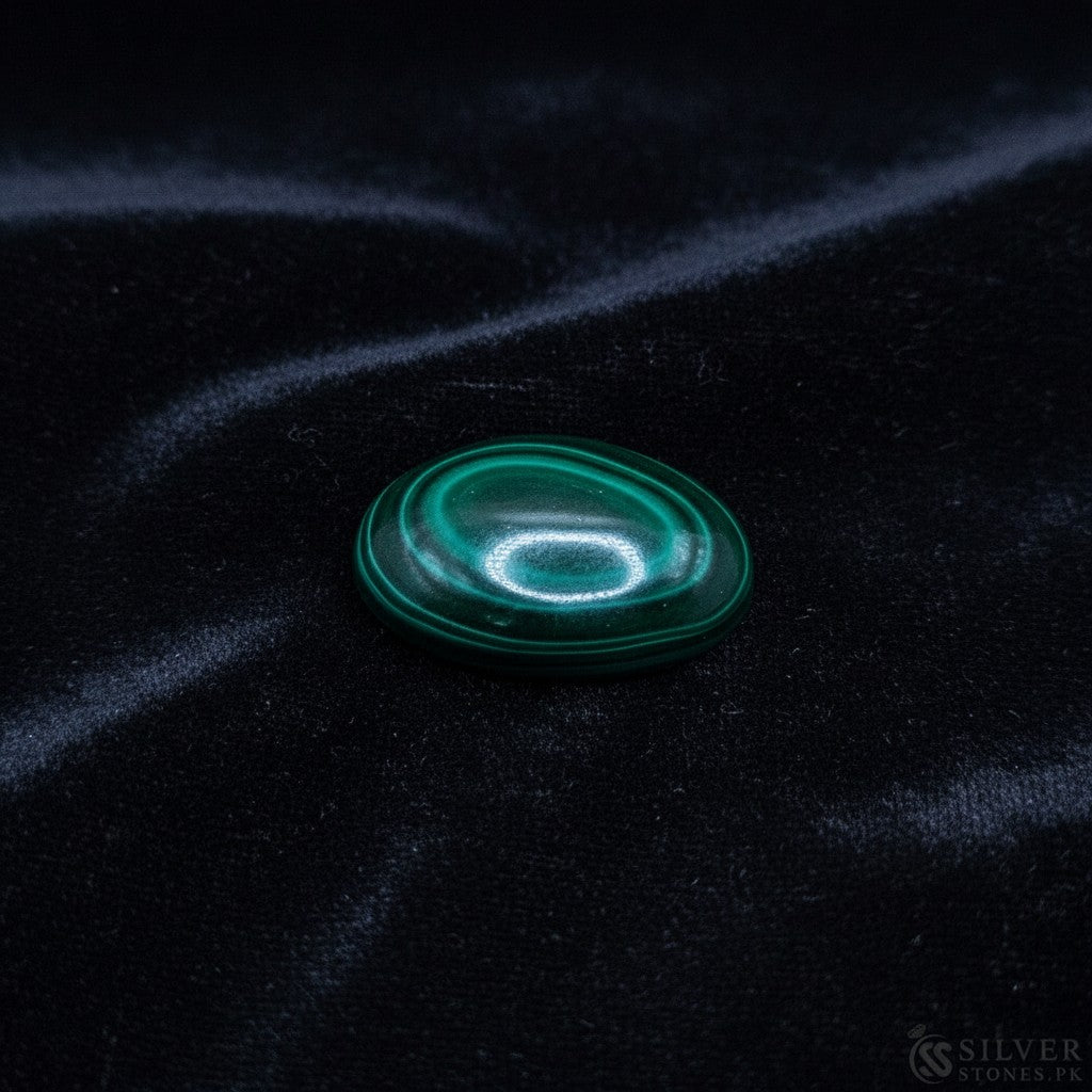 SilverStones.Pk oval cabochon real malachite stone with vibrant green swirls, believed to aid kidney health.